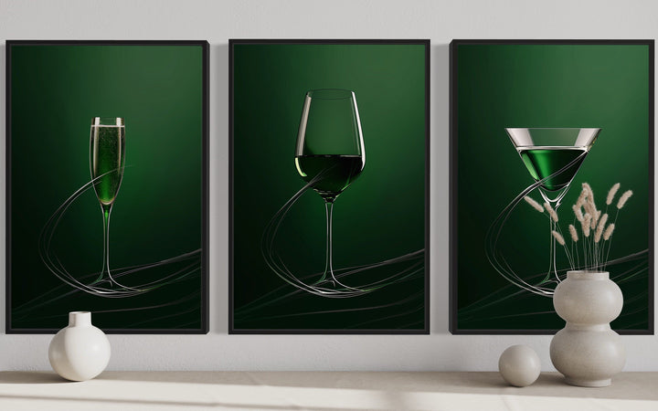 Triptych of emerald green framed wall art featuring a champagne flute, wine glass, and martini glass.