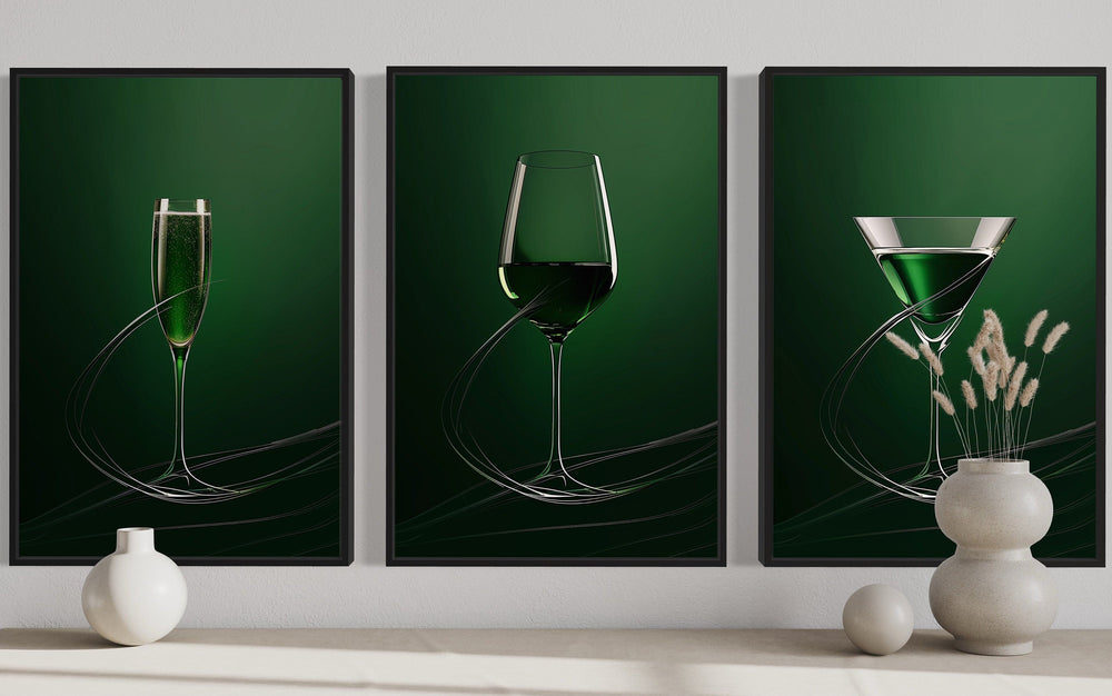 Triptych of emerald green framed wall art featuring a champagne flute, wine glass, and martini glass.