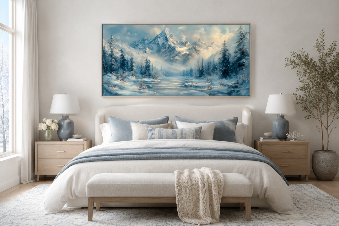 Winter mountain wall art canvas with snowy peaks and a frozen lake above a neutral-toned bed.