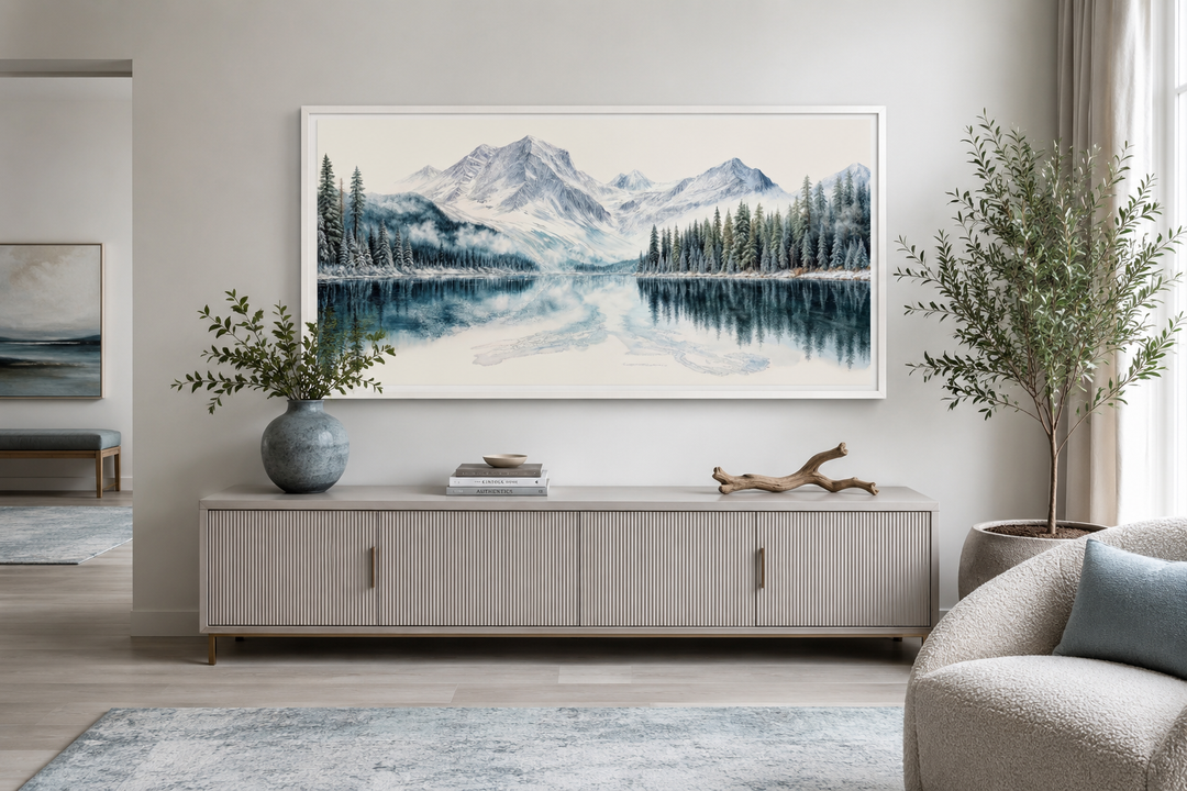 Framed winter mountain lake canvas print with pine tree forest above a modern sideboard.