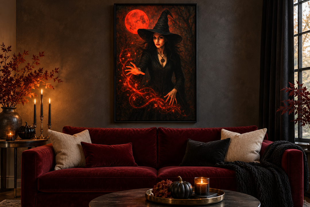 Gothic witch casting spells wall art with red bloody moon in a black frame above a red velvet sofa.