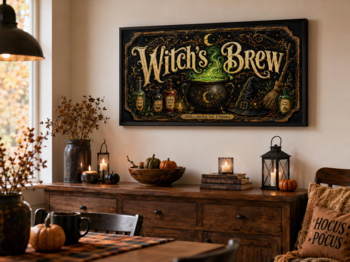 Vintage Witch's Brew black and gold canvas wall art above a wooden sideboard with Halloween decor.