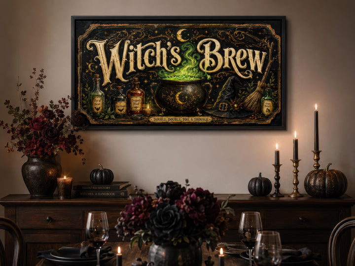 Vintage Witch's Brew canvas print with gold script and a glowing green cauldron on a black wall.