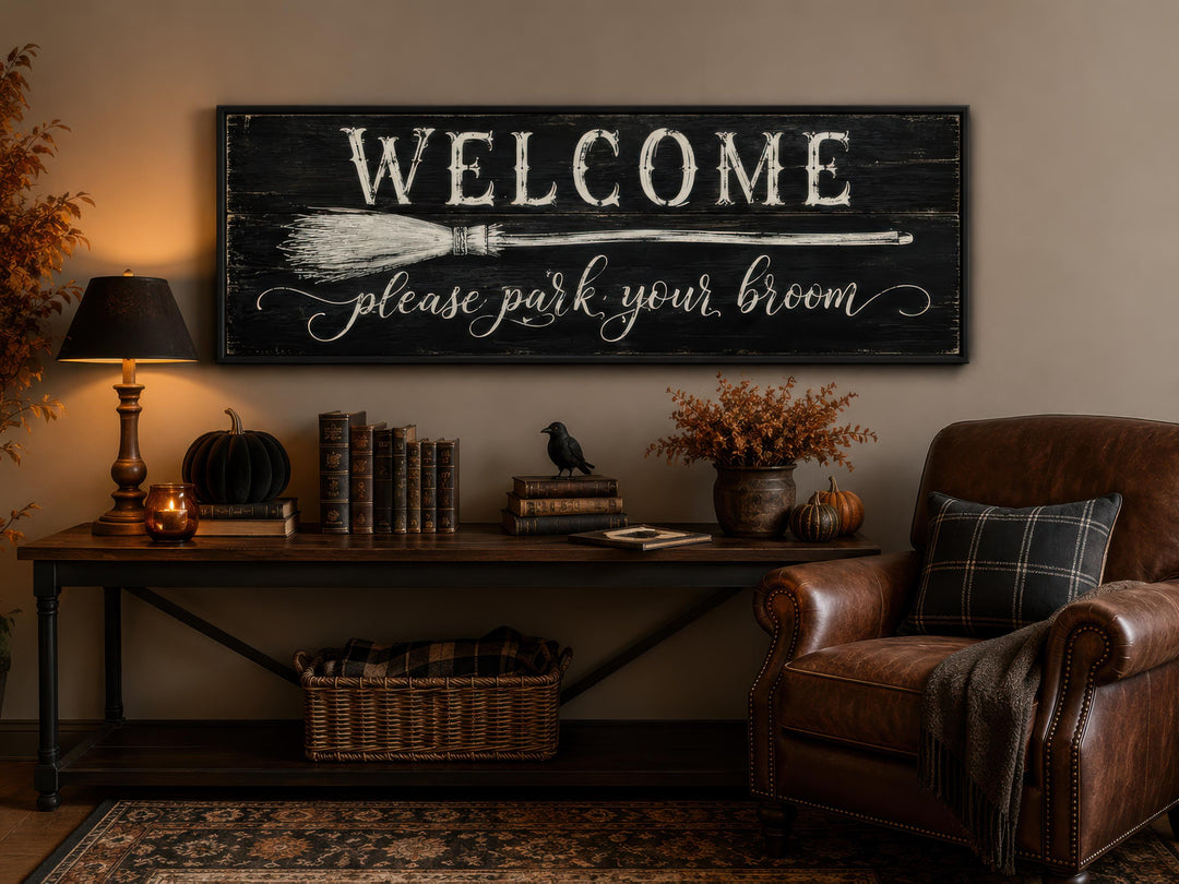 Witchy Halloween wall art sign reading "Welcome please park your broom" above a console table.