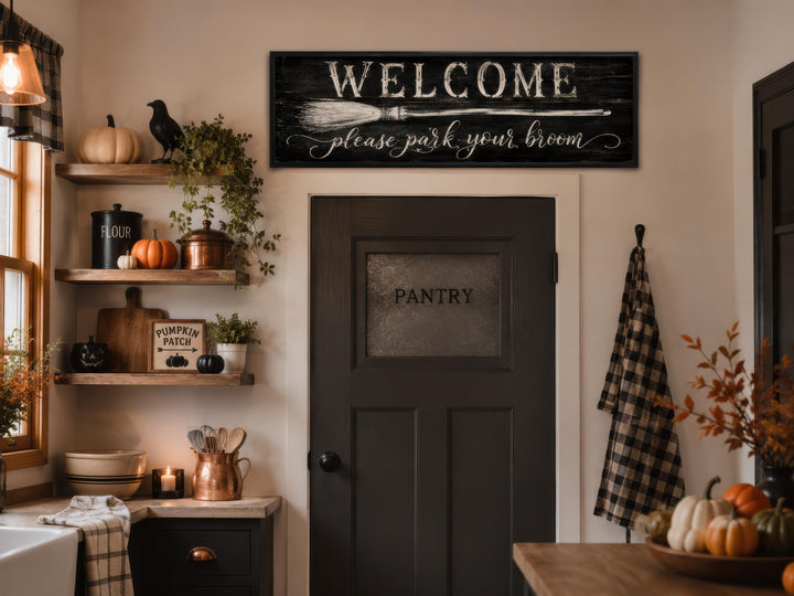 Witchy Halloween wall art sign with 'Welcome please park your broom' text above a pantry door.