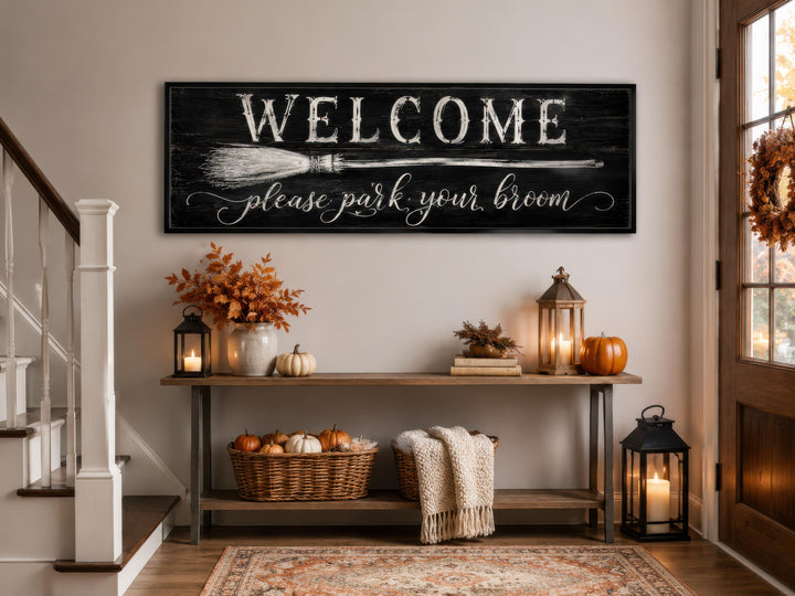 Witchy Halloween wall art sign with 'Welcome please park your broom' text above a console table.
