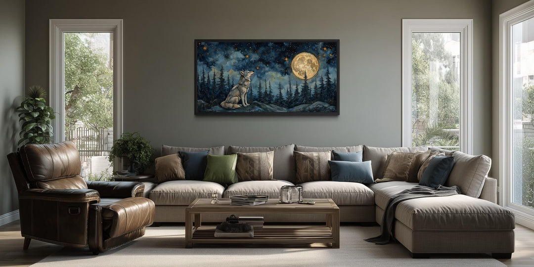 A horizontal canvas of a wolf howling under a full moon hangs above a sofa in a rustic living room.