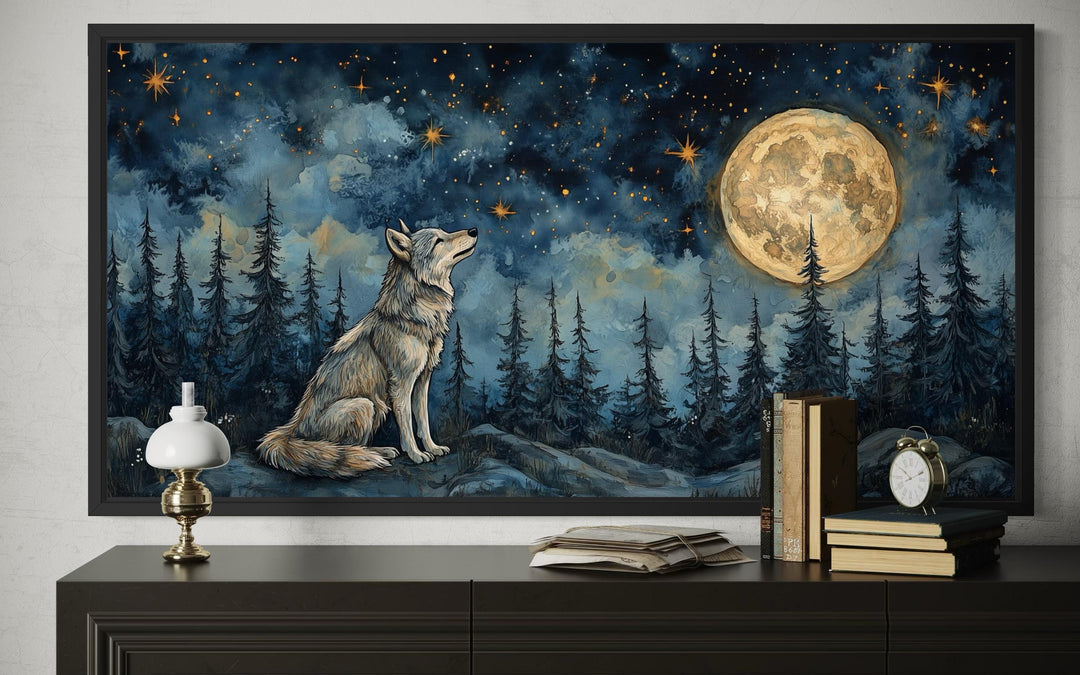 A framed canvas print of a wolf sitting under a full moon in a starry night forest.