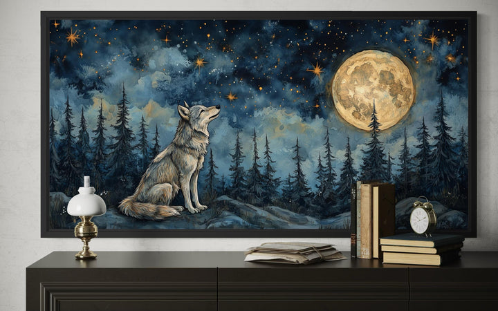 A framed canvas print of a wolf sitting under a full moon in a starry night forest.