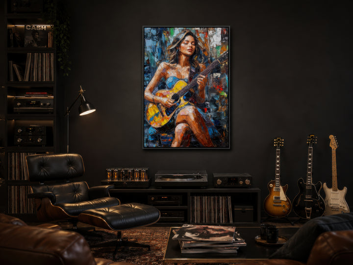A vibrant abstract canvas of a woman playing guitar hangs in a moody, modern music room.