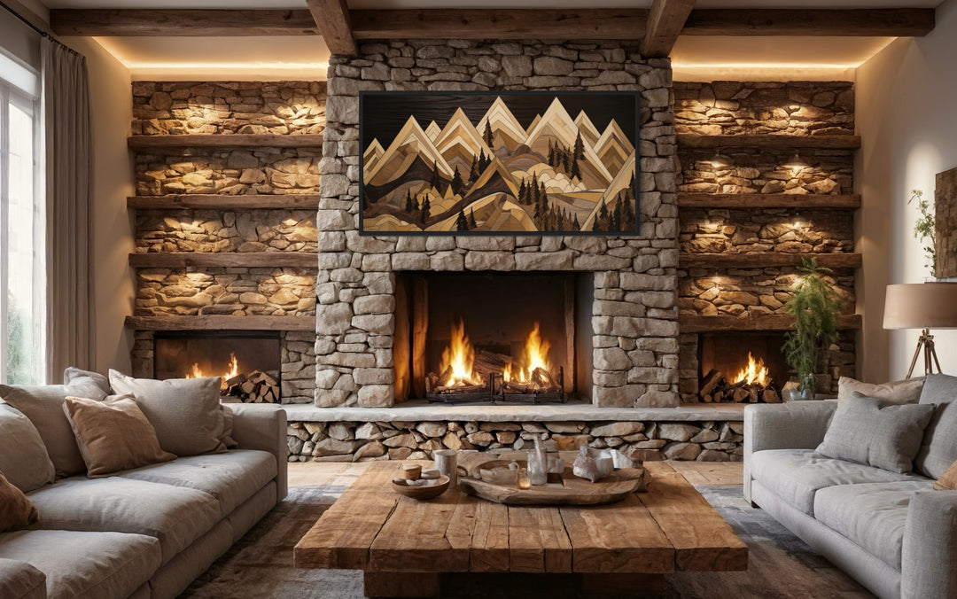 Framed wood mountain painting canvas wall art hanging above a stone fireplace in a rustic cabin.