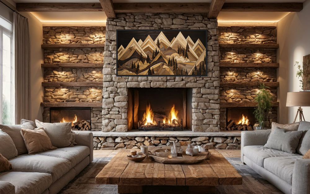 Framed wood mountain painting canvas wall art hanging above a stone fireplace in a rustic cabin.