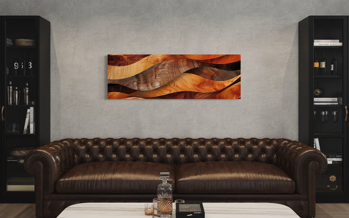 Horizontal framed canvas wall art with a rustic wood texture design above a brown leather sofa.