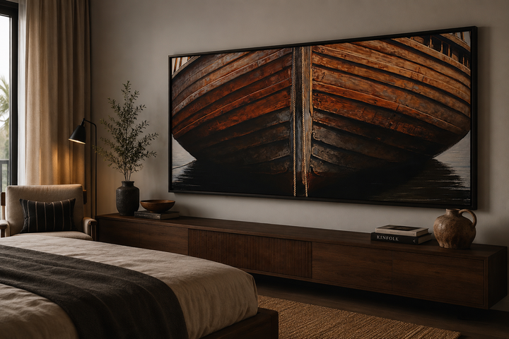 Large framed canvas print of a rustic wooden boat hull hanging above a dark wood media console.