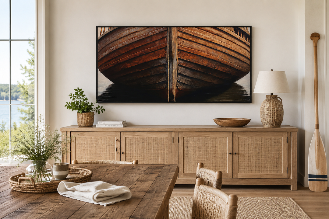 Framed canvas print of a rustic wooden boat hull mounted above a sideboard in a lake house dining room.
