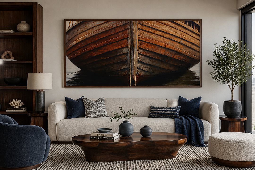 Large framed canvas print of a rustic wooden boat hull hanging above a modern sofa in a living room.