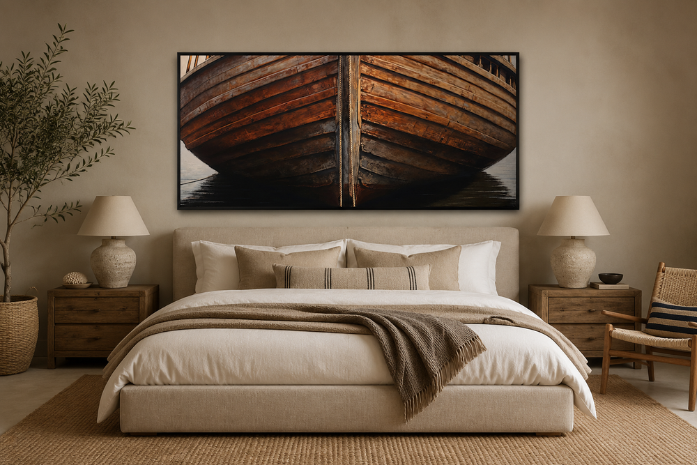 A large framed canvas print of a rustic wooden boat hull hanging above a bed in a neutral bedroom.