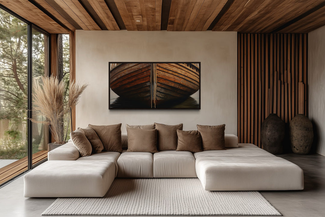 Framed canvas print of a rustic wooden boat hull hanging above a modern sectional sofa.