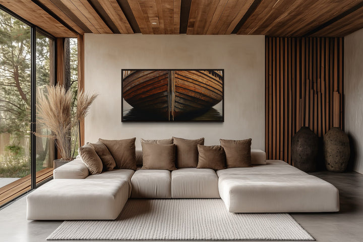 Framed canvas print of a rustic wooden boat hull hanging above a modern sectional sofa.