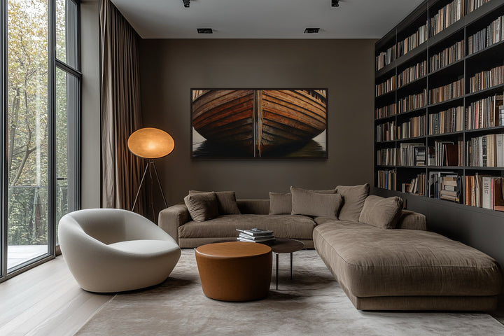 Framed canvas print of a rustic wooden boat hull on a dark wall in a modern living room.