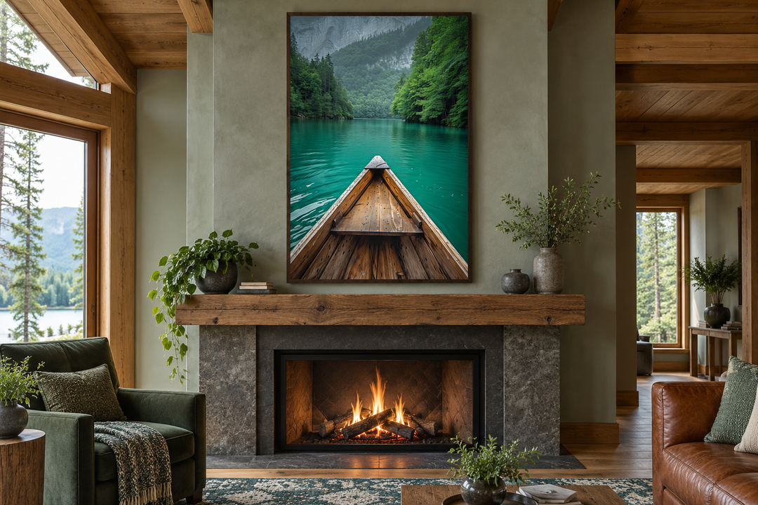 Vertical framed canvas wall art of a wooden canoe on an emerald green lake above a fireplace.
