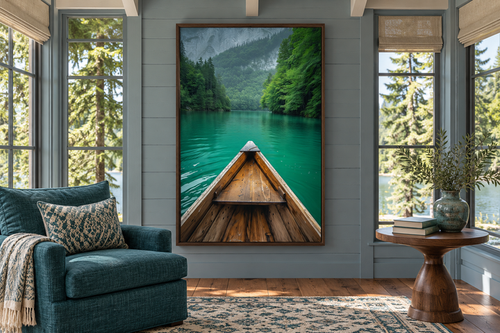 Vertical framed canvas wall art of a wooden canoe on an emerald green lake in a forest.