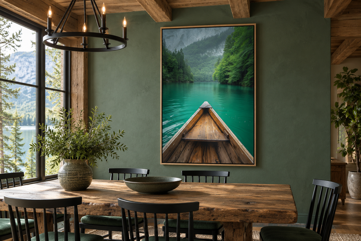 Vertical framed canvas wall art of a wooden canoe on an emerald green lake in a rustic dining room.