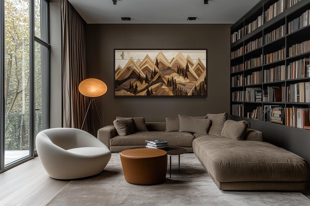 Framed horizontal canvas wall art of layered wooden mountains and a soaring eagle in a modern room.