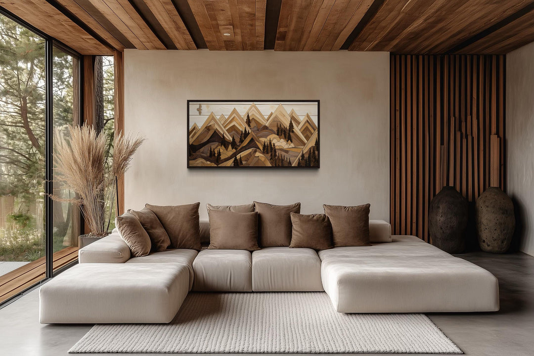 Wooden mountain with eagle framed canvas wall art hanging above a modern sofa in a rustic cabin.