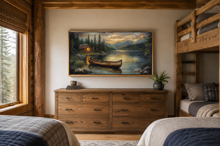 Rustic canvas wall art of a wooden canoe on a lake at sunset, hanging above a wooden dresser.