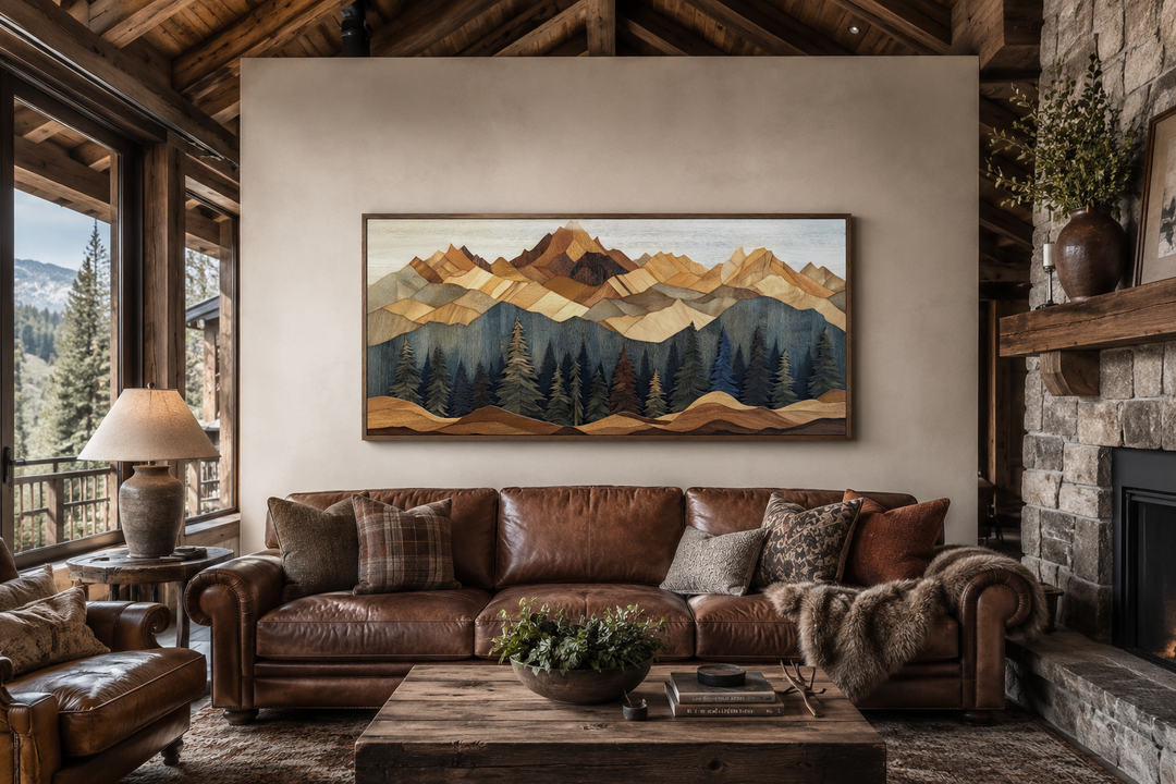 Wooden mountain and pine tree framed canvas wall art above a leather sofa in a rustic cabin living room.