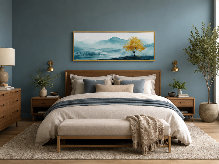 Yellow tree on teal mountain landscape long horizontal wall art above a bed in a modern bedroom.