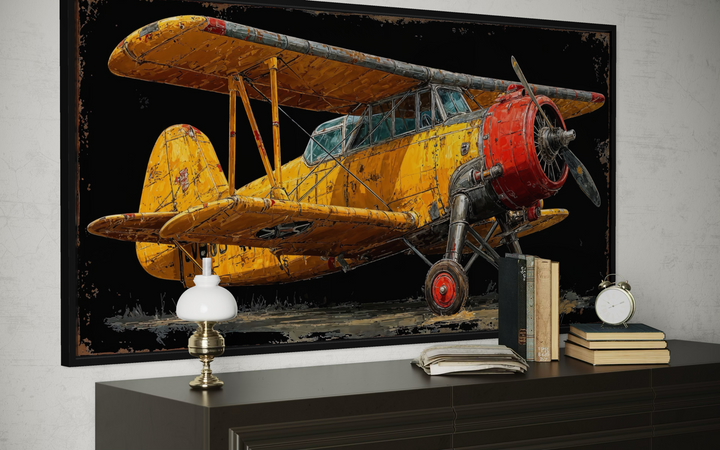 Yellow vintage biplane framed canvas wall art displayed above a dark wood dresser with decor.
