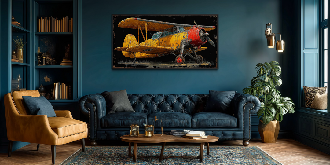 Yellow vintage biplane framed canvas wall art displayed in a moody, dark blue living room.