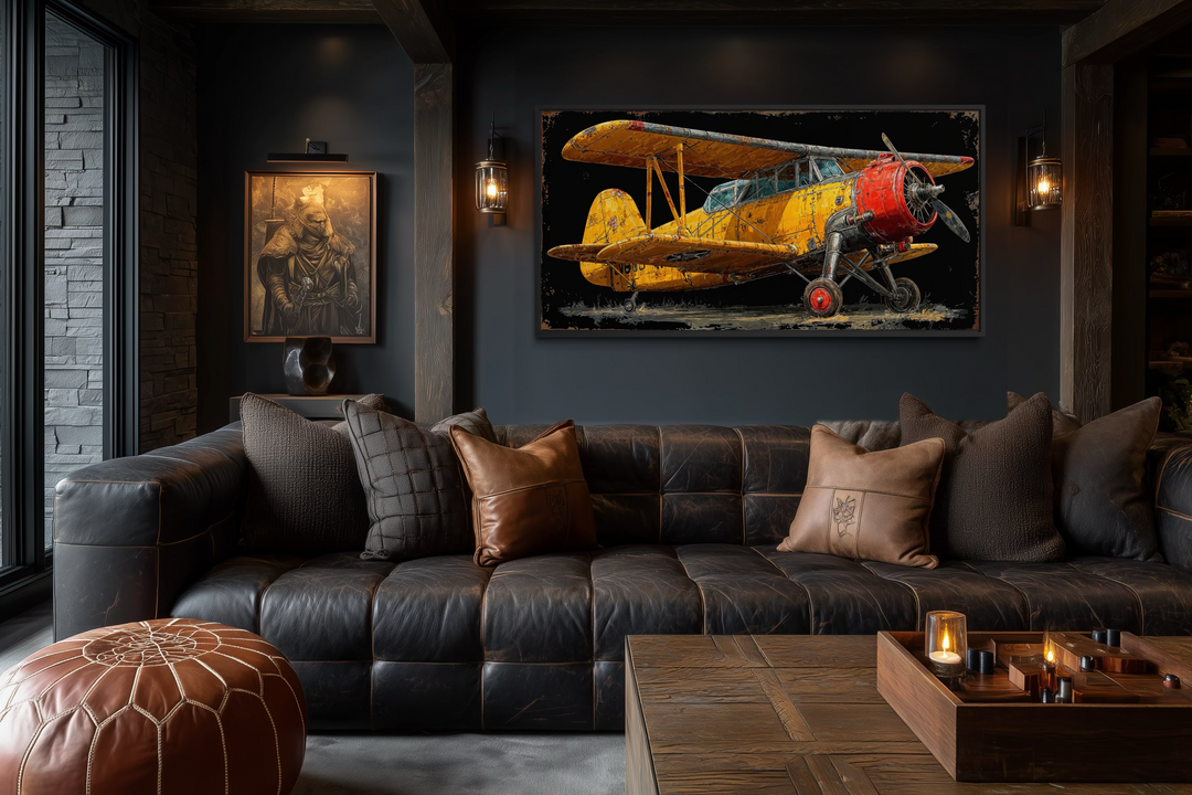 Yellow vintage biplane framed canvas wall art displayed in a dark, industrial-style living room.