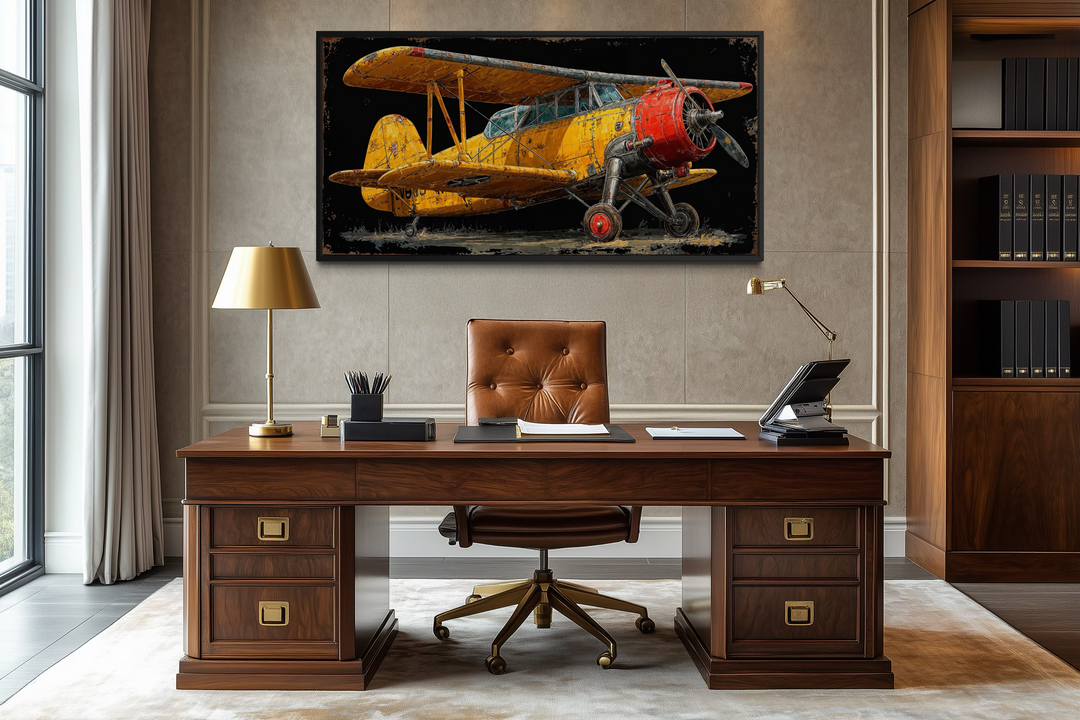 Yellow vintage airplane framed canvas wall art displayed above a desk in a classic office setting.