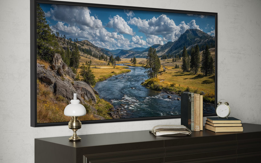 Framed canvas wall art of a Yellowstone National Park river landscape displayed above a dresser.