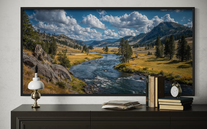 Framed panoramic canvas of Yellowstone National Park landscape above a dark console table.