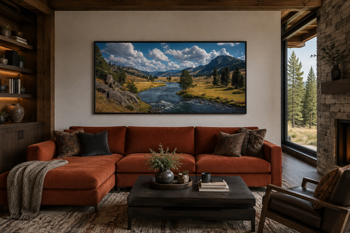 Framed panoramic canvas art of Yellowstone National Park landscape above a rustic living room sofa.
