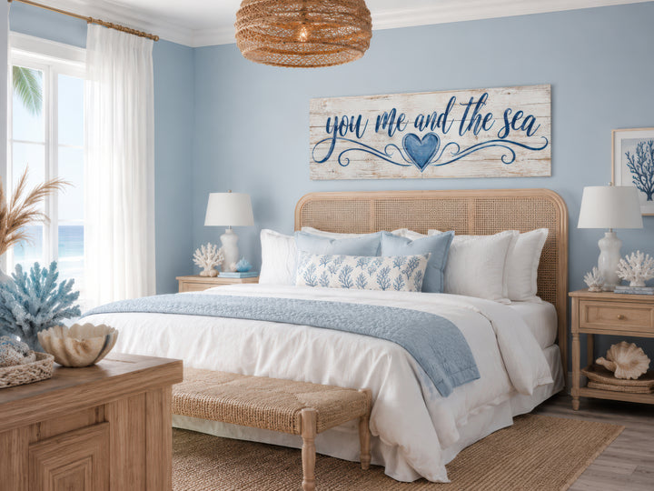 You Me And The Sea wall art above a bed in a coastal-style bedroom with blue and white decor.