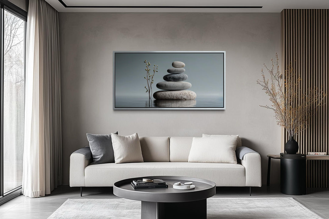 Zen stacked stones horizontal grey minimalist wall art displayed above a modern sofa.