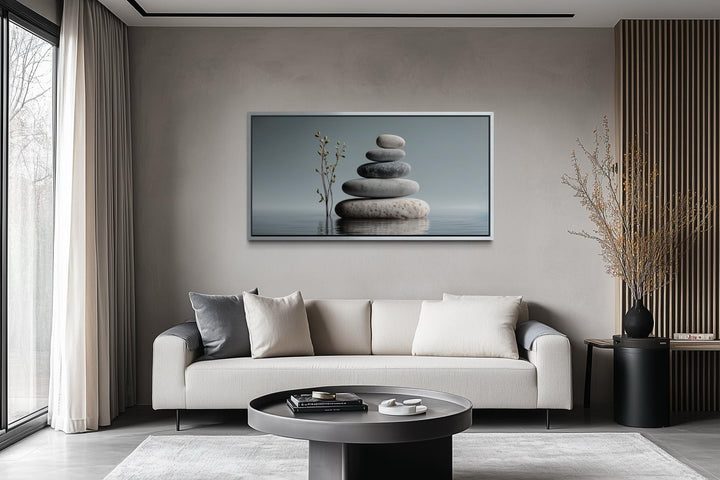 Zen stacked stones horizontal grey minimalist wall art displayed above a modern sofa.