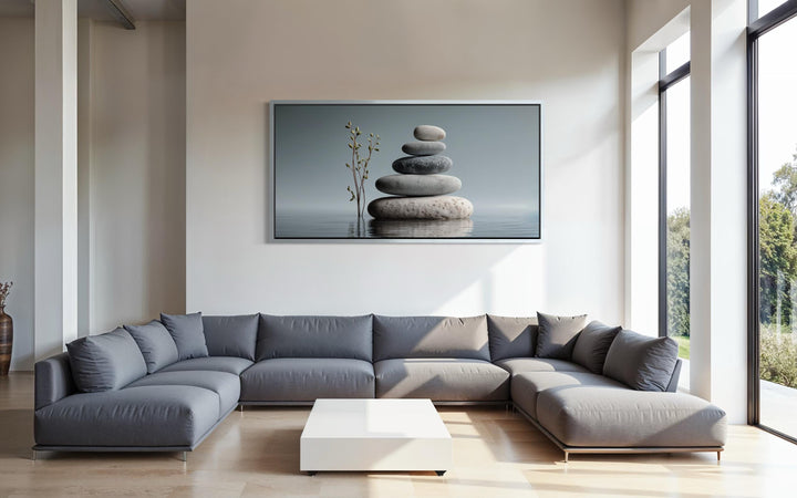 Zen stacked stones horizontal grey minimalist wall art displayed above a modern grey sectional sofa.