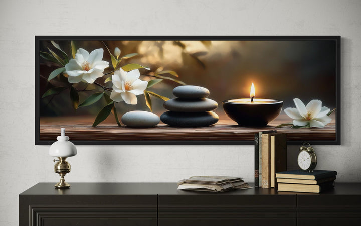Zen Stones, Candle and Magnolia Flowers Long Horizontal Framed Canvas Wall Art above a console.