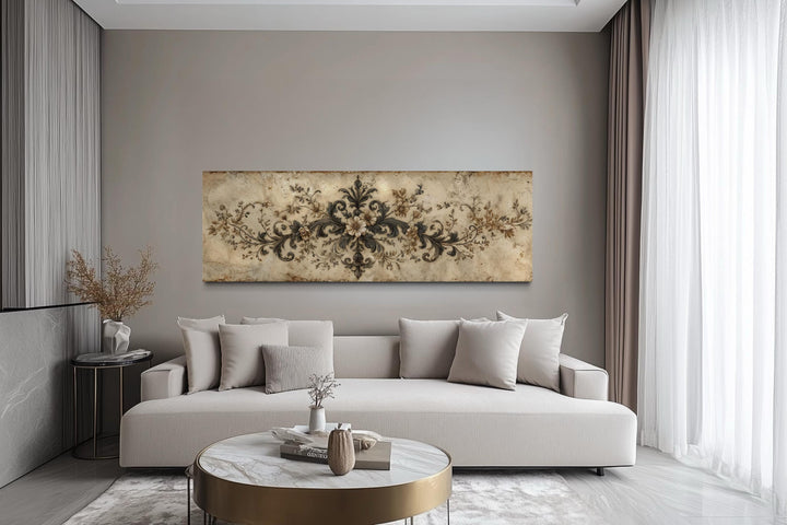 Antique neutral long narrow damask canvas wall art featuring a French ornamental design above a sofa.