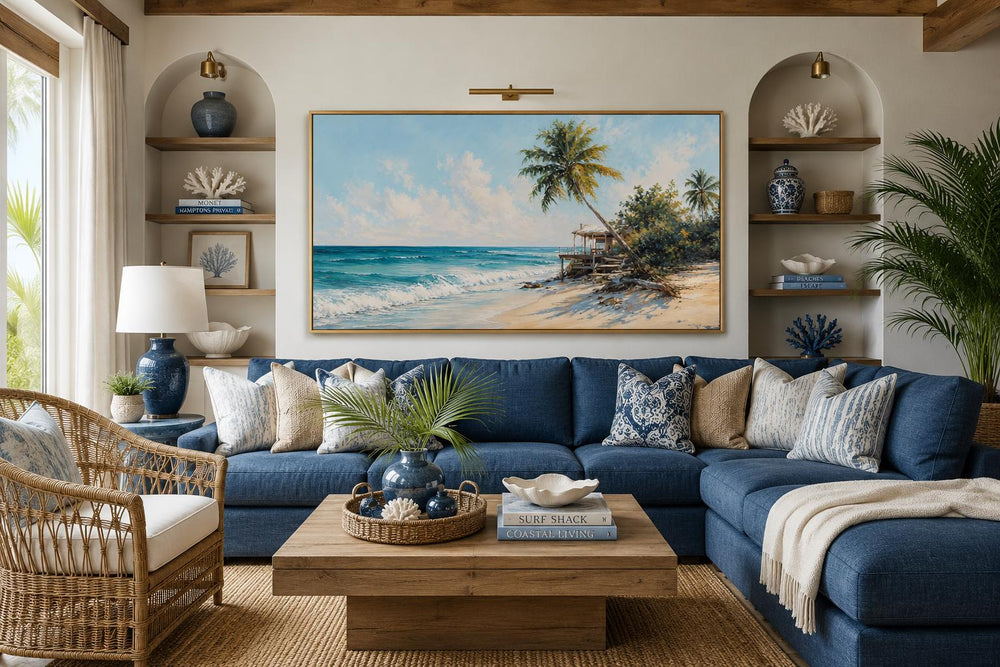 Tropical beach wall art with palm trees and turquoise waves above a blue sectional sofa.