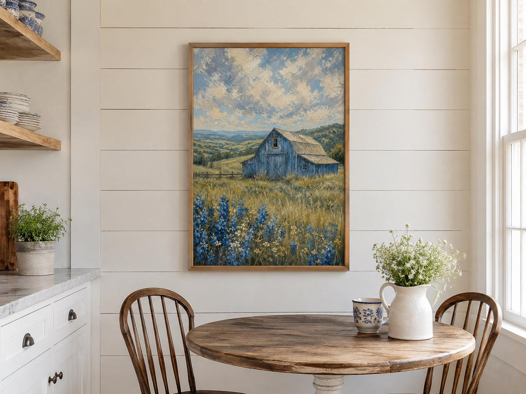 Vertical canvas art of a blue barn in a bluebonnet field hanging in a farmhouse kitchen.
