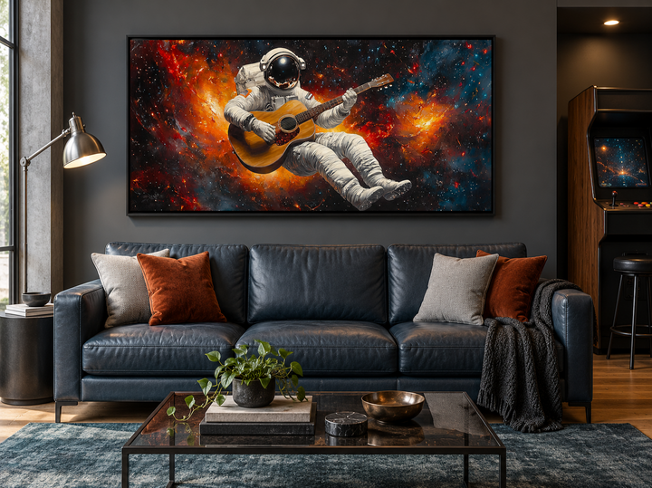 Astronaut playing guitar framed canvas wall art above a blue sofa in a modern living room.