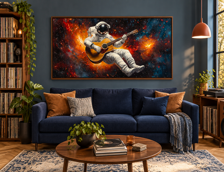Astronaut playing guitar framed canvas wall art above a blue sofa in a modern music lounge.