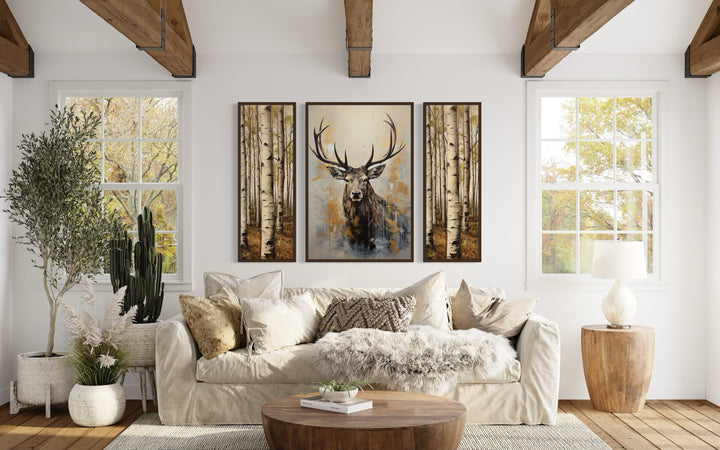 Set Of 3 Deer Flanked By Trees Framed Canvas Wall Art above beige couch